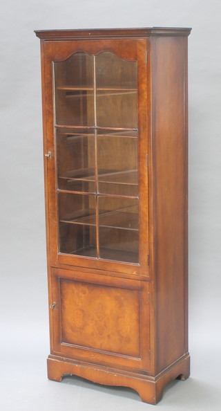 A mahogany bookcase enclosed by glazed panelled doors above a cupboard 64 1/2"h x 23 1/2"w x 14.5"
