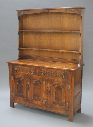 An oak dresser fitted 2 long drawers above a triple cupboard by Webber 66 1/2"h x 48"w x 16 1/2"d 