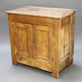 A rectangular elm cabinet enclosed by panelled doors with shelved interior 36"h x 37"w x 23"d 