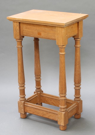 A rectangular oak occasional table raised on turned supports with box stretcher 33"h x 20"w x 13 1/2d 