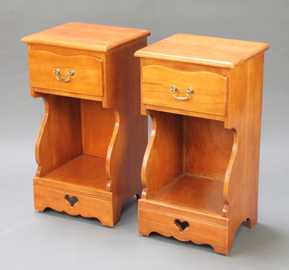A pair of pine bedside cabinets each fitted 1 serpentine fronted drawer above a recess, with pierced decoration 28 1/2" x 15"w x 13"d 