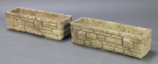 A pair of concrete rectangular garden planters in the form of brick work 8"h x 36"w x 11"d