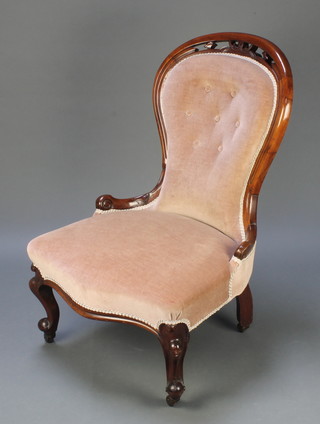 A Victorian mahogany framed balloon back nursing chair upholstered in mushroom buttoned material raised on cabriole supports 