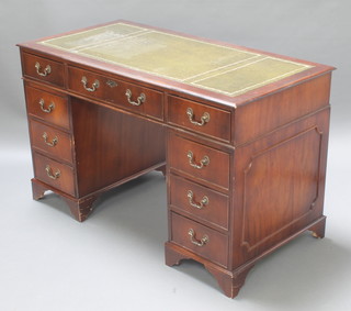 A Georgian style mahogany kneehole desk with green inset writing surface above 1 long and 8 short drawers, raised on bracket feet 29"h x 48"w x 24"d 