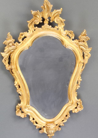 A 19th Century shield shaped plate mirror contained in a carved gilt frame 25"h x 17"w 