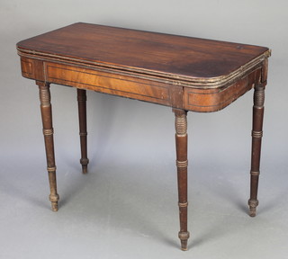 A Georgian mahogany tea table with inlaid ebony stringing raised on turned supports 28"h x 36"w x 17 1/2"d 