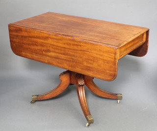 A Georgian mahogany pedestal Pembroke table fitted a drawer raised on turned column and tripod supports with brass caps and castors 28"h x 42"w x 21" when closed x 41" when open 