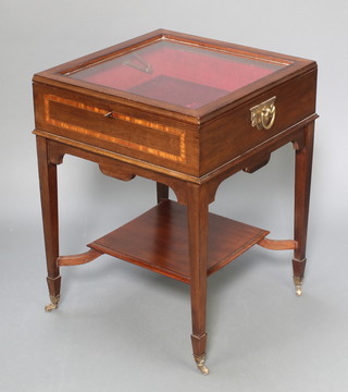 A square mahogany bijouterie table with undertier  raised on square tapered supports, spade feet with brass caps and castors 25 1/2"h x 19"w x 19"d 