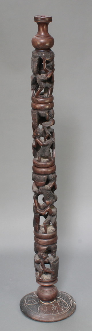 An African turned and pierced hardwood standard lamp decorated figures 55"h x 12" diam. to the base