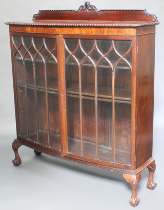 A Chippendale style mahogany bow front display cabinet fitted shelves enclosed by astragal glazed panelled doors raised on cabriole supports 54"h x 47 1/2"w x 15"d 