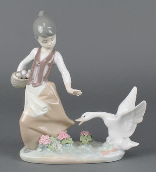 A Lladro figure group of a girl with goose and basket of eggs 1288 8 1/2" 