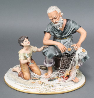 A Capodimonte group of a fisherman and boy emptying his net 12" 