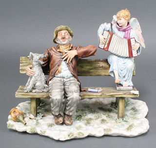 A Capodimonte group of a singing tramp and a dog sitting on a bench accompanied by an accordion playing angel 12 1/2" 