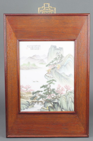 A 20th Century Chinese painted porcelain panel with an extensive mountainous landscape scene and figures with script 11 1/2" x 8 3/4" in a hardwood frame