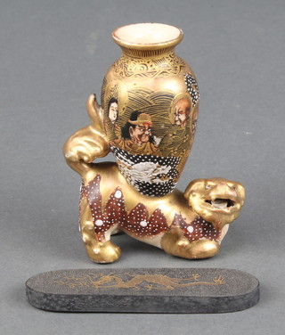 An early 20th Century Satsuma vase decorated with deities supported on the back of a Shi Shi 3" and a Chinese tea block 