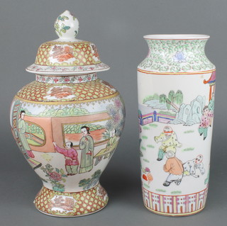 A mid 20th Century famille rose baluster vase and cover decorated with panels of figures 11 1/2" and a mid 20th Century famille rose cylindrical vase decorated with figures in a garden 12" 