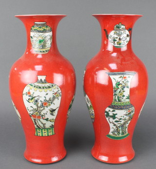 A pair of Chinese 18th century style red ground oviform vases decorated with vases 16 1/2"  