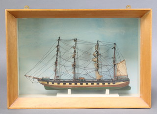 A wooden model of a 4 masted clipper contained in an oak case 9 1/2"h x 14"w x 4 1/2" 
