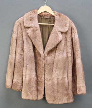 A lady's light coloured fur coat