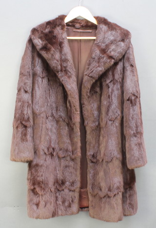 A lady's full length brown fur coat 