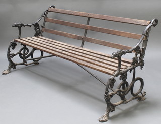 A Coalbrookdale style slatted garden bench, the pierced cast iron ends with fig leaf and lion mask decoration 30"h x 62"w x 25"d 
