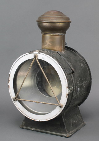 A circular French railway lantern contained in a metal case, the side marked SNCF 19" 
