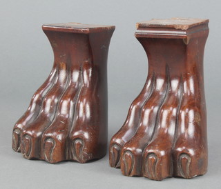 A pair of carved mahogany door stops in the form of paw feet 4" x 3 1/2" x 3 1/2" 