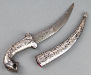 An Indian dagger with 5" etched blade contained in a niello scabbard, the handle in the form of a mythical beast 