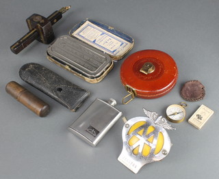 A French brass pocket compass in a gilt case, a beehive radiator badge 2E65789, a military issue tire pressure gauge 1942 and other curios 