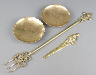A brass paper knife the handle decorated a seated Pan 7", a toasting fork and 2 Chinese circular brass dishes 5 1/2" 