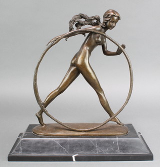 An Art Deco style bronze figure of a standing girl with hoop raised on a stepped marble base 16"h x 16"w x 7"d 