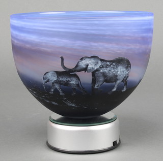 An etched cameo bowl decorated with a herd of elephants 7" together with an illuminated rotating base 