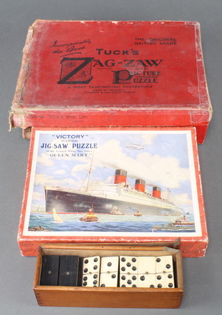 A set of bone and ebony dominoes together with a Victory jigsaw puzzle Queen Mary, a Tuck's Zag-zaw puzzle  