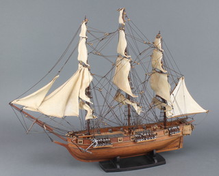 A wooden model of a 3 masted frigate 17"h x 19"l x 4"w 