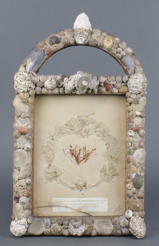 A Victorian arched frame decorated shells 10" x 9 1/2", some damage