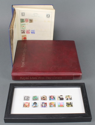 An album of GB mint presentation stamps and first day covers together with a blue Victory album of used world stamps, 12 GB presentation stamps - Classic Childrens TV framed and a small collection of loose stamps 