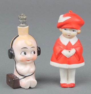 A Goebel Mabel Lucie Attwell scent bottle in the form of a seated baby wearing headphones seated beside a radio 3" and a Mabel Lucie Attwell bisque figure of a girl 3"  
