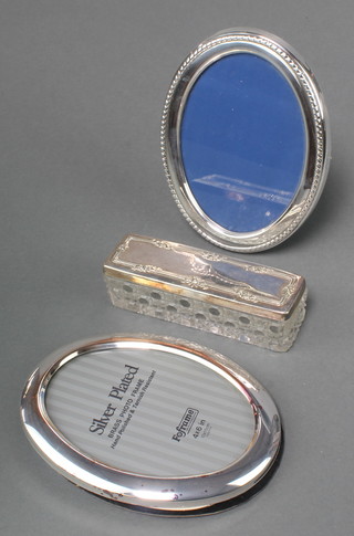 2 oval silver plated photograph frames and a ditto toilet jar 