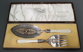 A cased pair of Edwardian silver plated, pierced and chased fish servers 