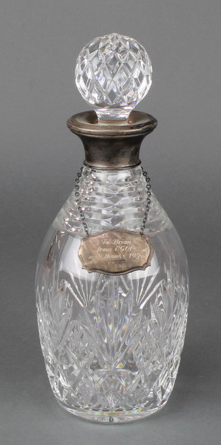A cut glass mallet shaped decanter and stopper with silver collar and a silver spirit label Birmingham 1990 
