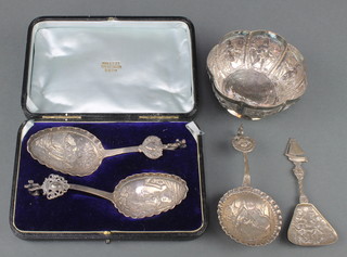 A pair of Continental repousse silver cased serving spoons, 2 others and an Indian repousse bowl 190 grams 
