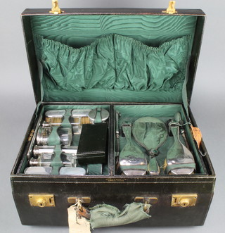 A leather fitted toilet case containing 5 silver mounted bottles and boxes together with a 7 piece brush set, London 1913 Maker Mappin & Webb, with outer cover 