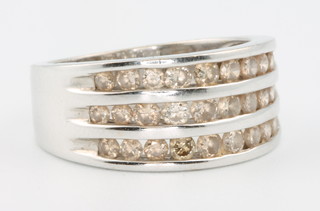 An 18ct white gold channel set diamond ring, size N, 7 grams