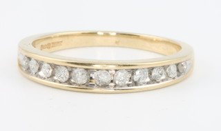 A 9ct yellow gold channel set diamond ring size O 