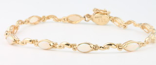 A 14ct yellow gold opal set bracelet 