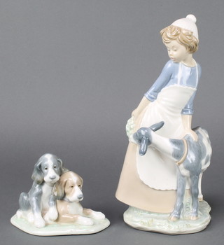 A Nao group of a young girl with goat 12 1/2", a ditto of 2 puppies 6" 