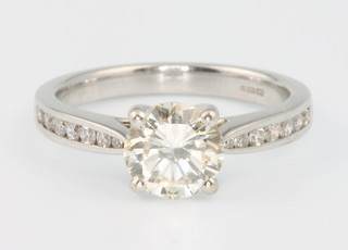 An 18ct white gold single stone brilliant cut diamond ring, approx. 1.2ct , the shoulders with 7 brilliant cut diamonds, size L, colour K, clarity VS2 