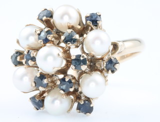An 18ct yellow gold pearl and sapphire set dress ring size O