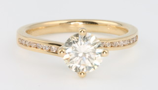 An 18ct yellow gold single stone brilliant cut diamond ring approx 1.05ct, colour K, clarity SI2, the shoulders set each with 8 brilliant cut diamonds, size L with EDR certificate 
