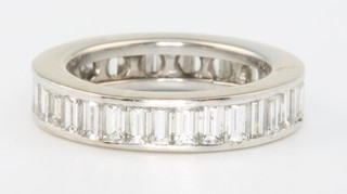 An 18ct white gold baguette cut diamond full eternity ring size L, approx. 3ct